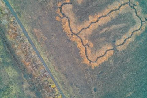 Complex platoon strongpoint with a trench network in a rural field aerial view Stock Photos