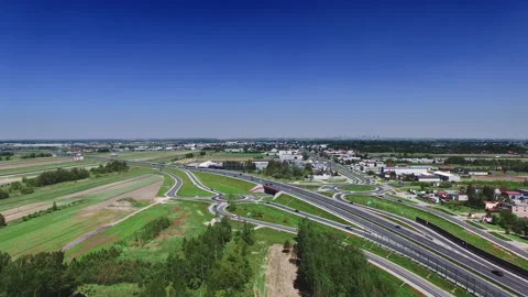Complex road junction. Sunny day, sunset. Modern Europe. Aerial high altitude Stock Footage 153098920
