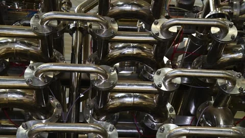 A complex system of metal pipes and connections is part of an industrial pl.. Video stock 343236692