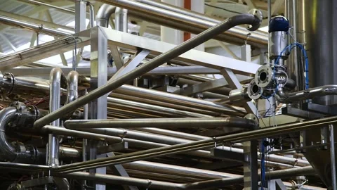 A complex system of metal pipes and connections is part of an industrial pl.. Stock Footage 343236694
