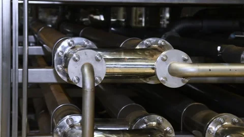 A complex system of metal pipes and connections is part of an industrial pl.. Stock Footage 343236731
