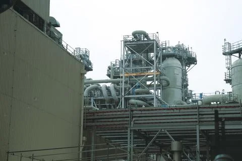 A complex system of pipes and assemblies in a plant for the production and tr Stock Photos