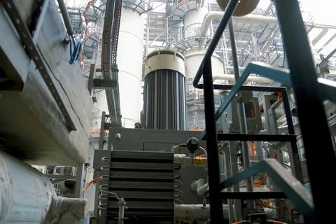 A complex system of pipes and assemblies in a plant for the production and tr Stock Photos
