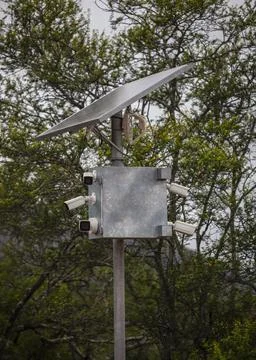 Complex of video cameras and motion sensors with solar panel and an antenna.. Stock Photos