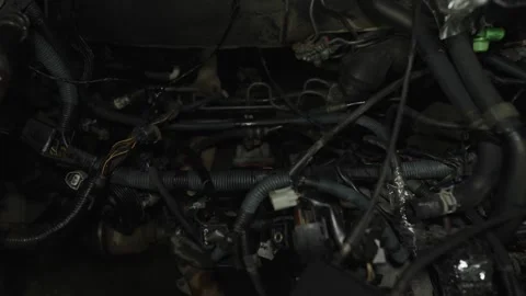 A complex view of a car engine bay filled with wires, hoses, and mechanical Stock Footage 340334637