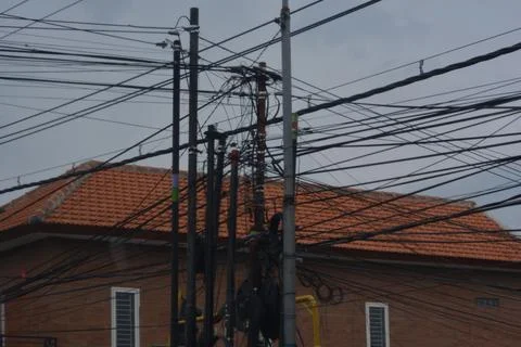 Complex web of urban power lines and cables Kediri Indonesia 13 February 2026 Stock Photos