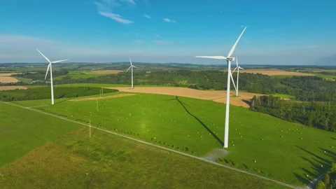 A complex of  wind power plants with spinning propellers in a hilly landscape. 動画素材 233835945