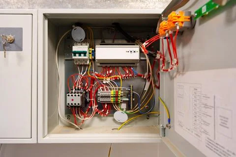 Complex wiring setup inside an electrical control cabinet for industrial Stock Photos