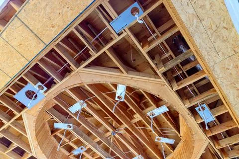 Complex wooden ceiling structure under construction with visible wiring Stock Photos