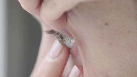 Complexity of putting on contact lenses. close-up of a female pupil in eye Stock Footage 91441663