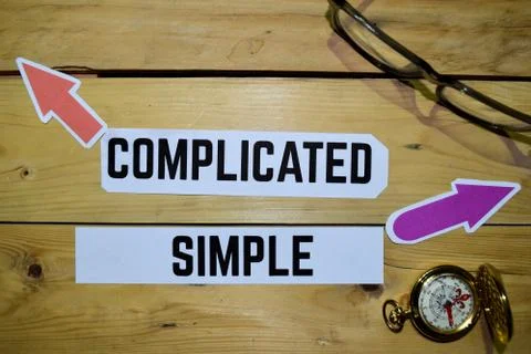 Complicated or Simple opposite direction signs with eyeglasse and compass Stock Photos