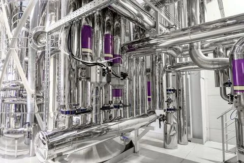 Complicated pipeline system in spacious workshop of plant Stock Photos