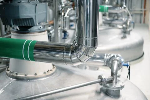 Complicated pipeline system in spacious workshop of plant Stock Photos