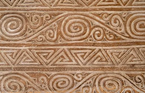 Complicated swirl and triangle patterns on an old wooden bench in pale brown Stock Photos