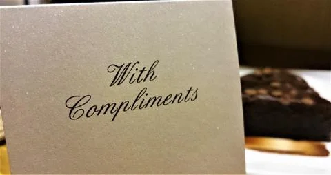 A With Compliments note in a hotel room Stock Photos