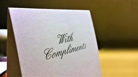 A With Compliments note in a hotel room Stock Photos