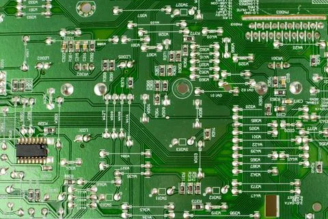 Components of microprocessor devices are installed on a printed circuit board Stock Photos