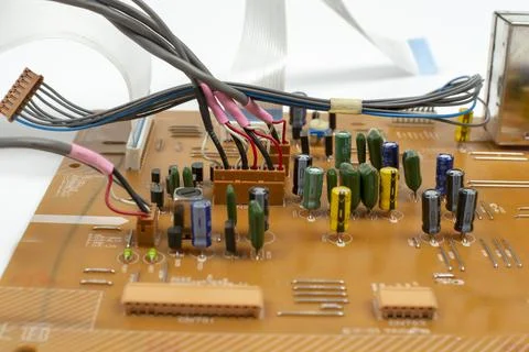 Components of microprocessor devices are installed on a printed circuit board Stock Photos