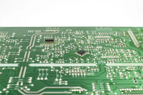 Components of microprocessor devices are installed on a printed circuit board Stock Photos