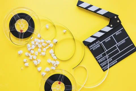 Composed clapboard with reels Stock Photos