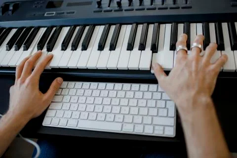 Composer hands on piano keys in recording studio. music production technology Stock Photos