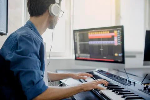 Composer hands on piano keys in recording studio. music production technology Stock Photos