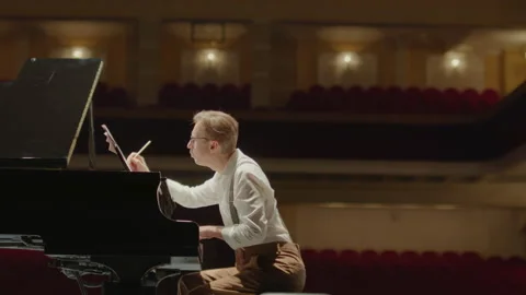 Composer Writing Piano Sheet Music and Throwing Paper Away Stock Footage 195050656
