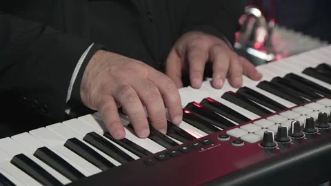 The composer's hands play electronic pianos. Stock Footage 228490099