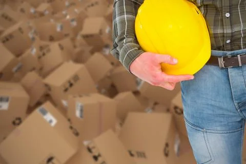 Composite 3d image of manual worker holding helmet Foto stock