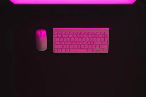 Composite of computer with blank screen and copy space on neon background Stockfoto's