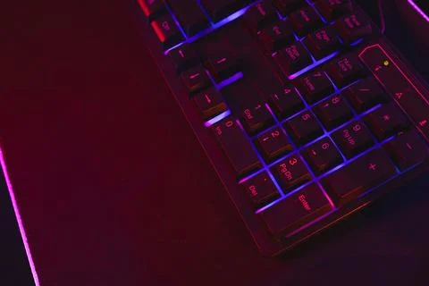 Composite of computer keyboard with copy space on neon background Foto stock