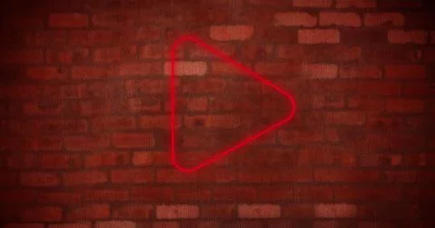 Composite of digital red play button icon glowing against brick wall, copy space Stock Photos