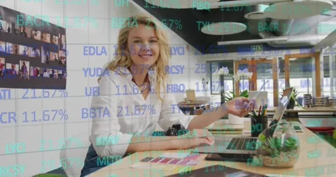 Composite of financial data processing over businesswoman using computer in Stock Footage 330179082