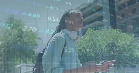 Composite of financial data processing over man using smartphone in city Stock Photos