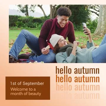 Composite of hello autumn text over happy diverse couple in autumn park Fotos Stock