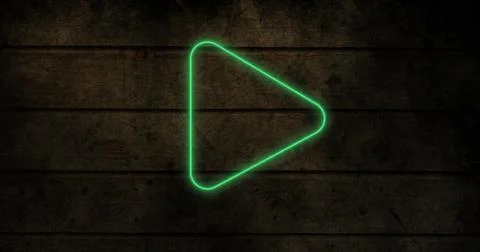 Composite of illuminated play button icon over wooden wall, copy space Stock Photos