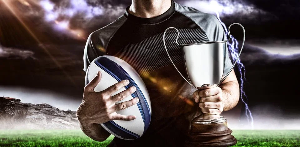 Composite image 3D of midsection of successful rugby player holding trophy and Stock Photos