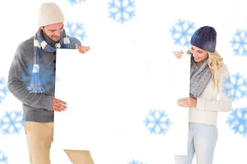 Composite image of attractive couple in winter fashion showing poster Ilustração Stock