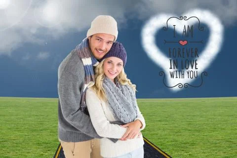 Composite image of attractive couple in winter fashion hugging Ilustração Stock
