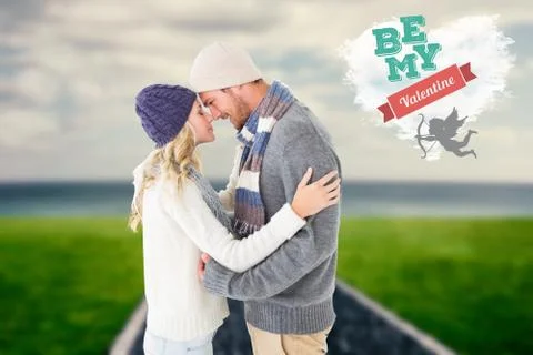 Composite image of attractive couple in winter fashion hugging Ilustração Stock