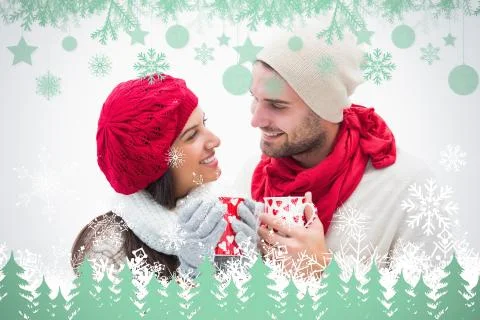 Composite image of attractive young couple in warm clothes holding mugs Illustrazione stock