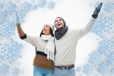 Composite image of attractive young couple in warm clothes with arms up Illustrazione stock