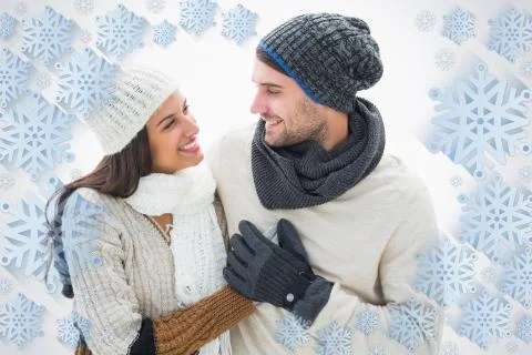 Composite image of attractive young couple in warm clothes Illustrazione stock