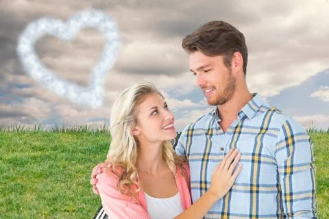 Composite image of attractive young couple smiling at each other Ilustração Stock