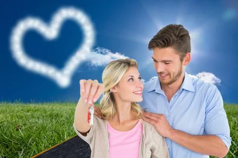Composite image of attractive young couple showing new house key Stock Illustration