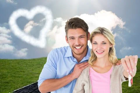 Composite image of attractive young couple showing new house key Stock Illustration