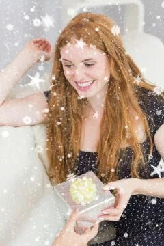 Composite image of beautiful young blond receiving a gift box on sofa Stock Illustration