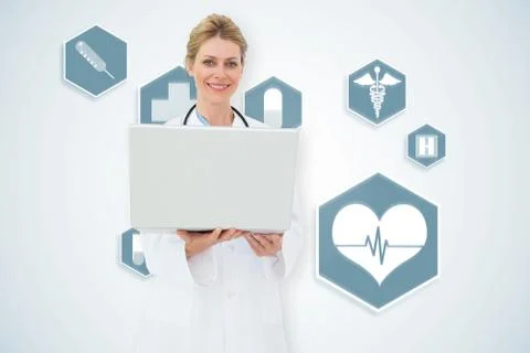 Composite image of blonde doctor using laptop 스톡 일러스트