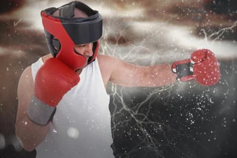 Composite image of boxer wearing head protector and gloves 写真素材