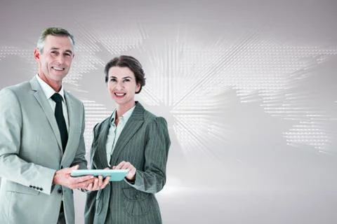 Composite image of business team using tablet pc Stock Photos